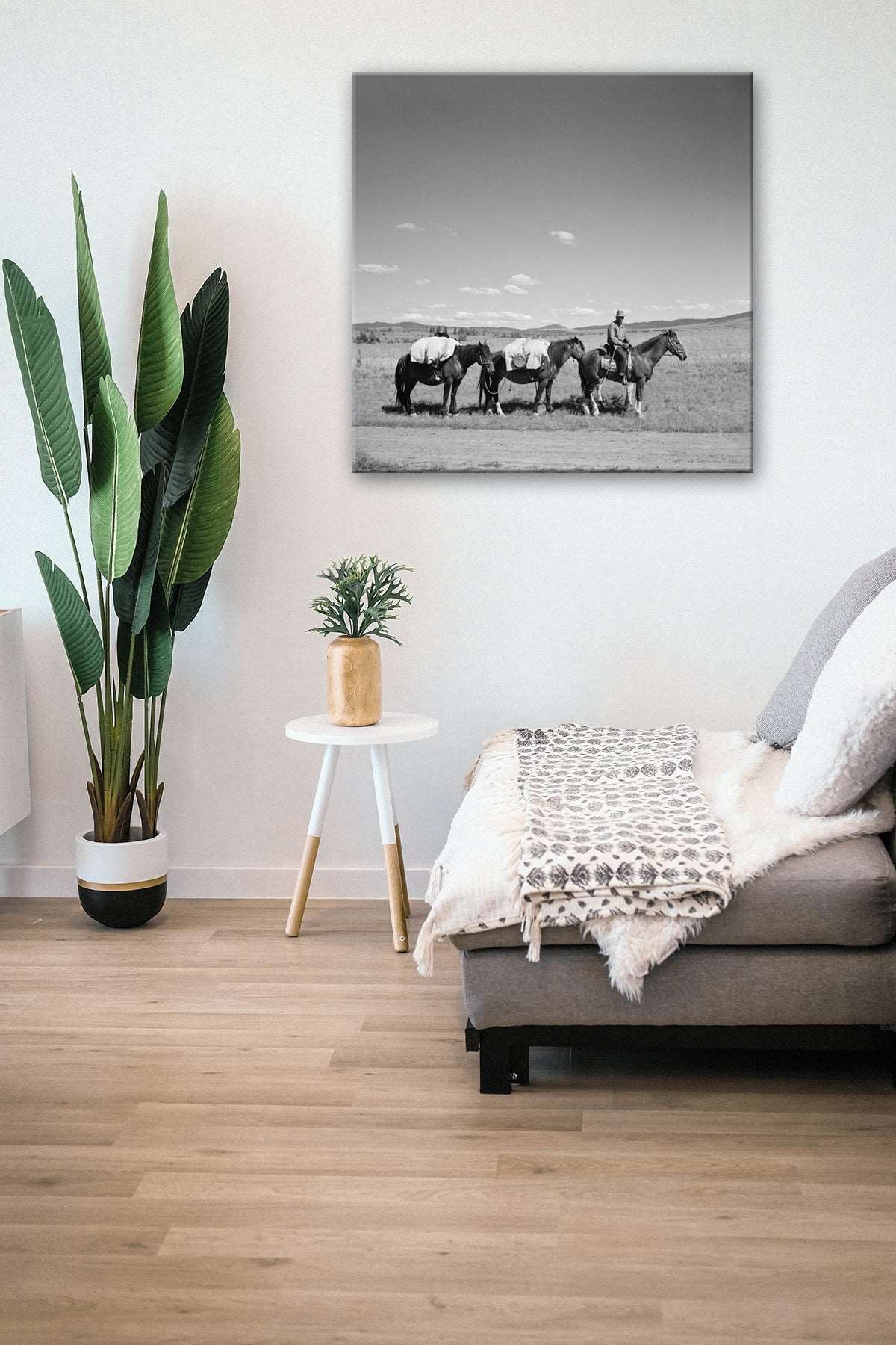 A living room feauturing a canvas print of a photograph of a sheep herder in Oregon