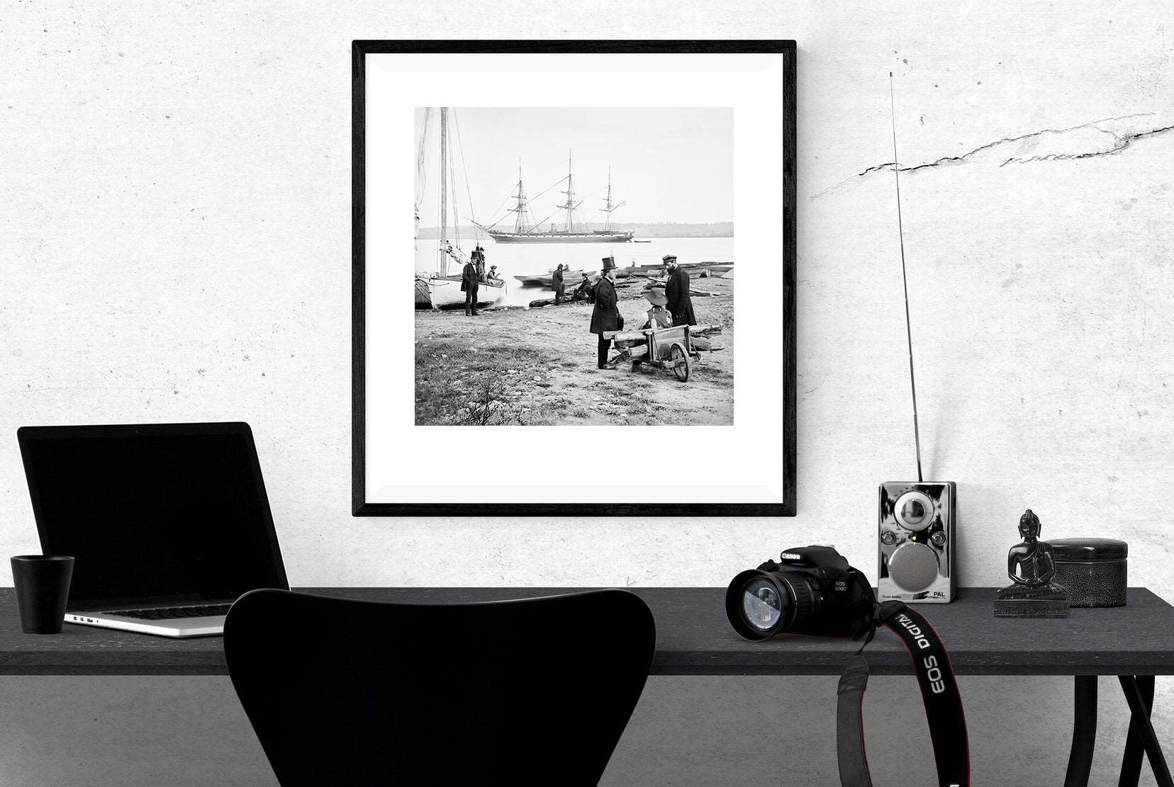 A rendering of a desk space with a framed vintage photograph hanging on the wall