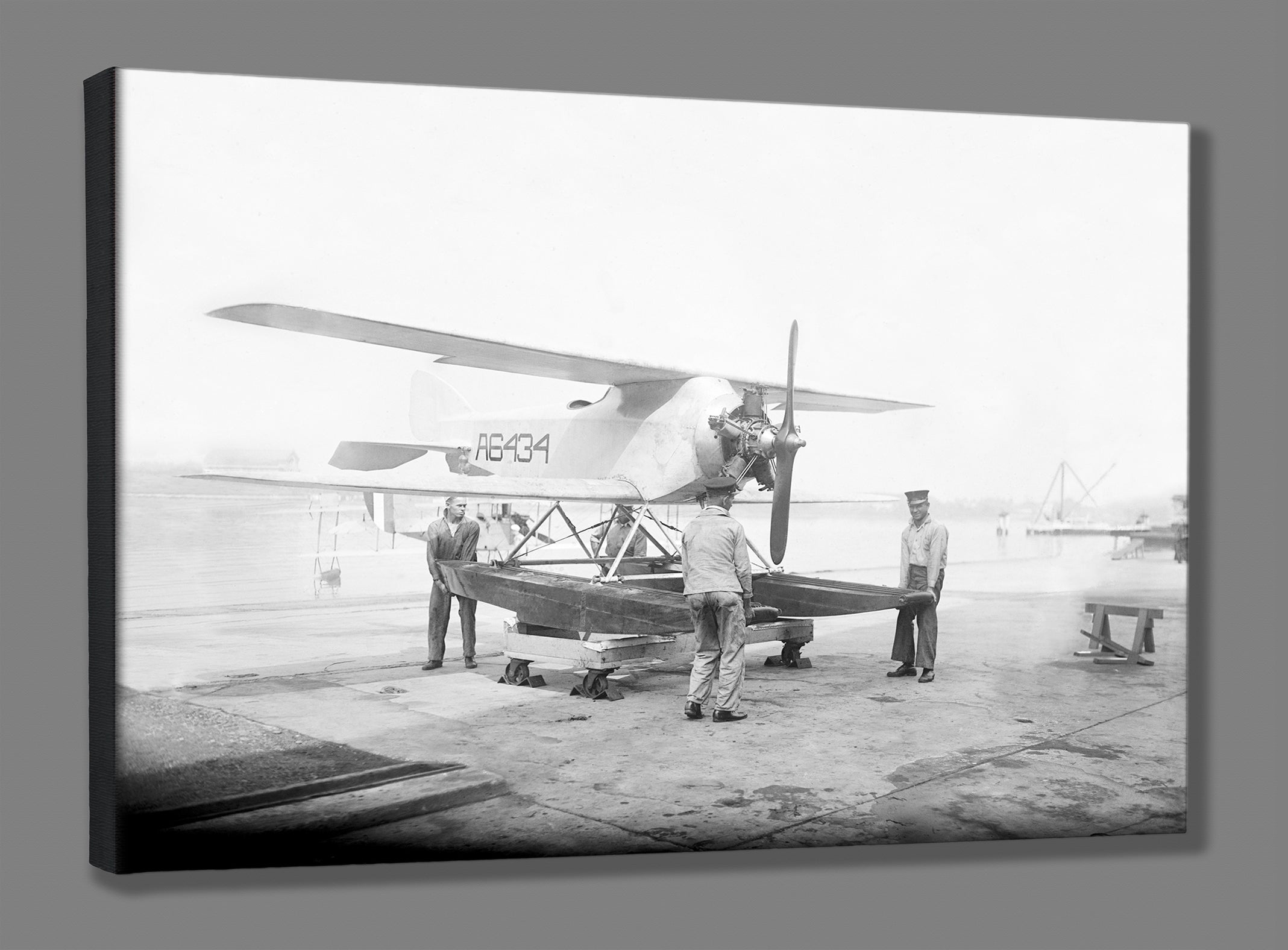 A canvas reproduction of a vintage photograph of men with a submarine plane