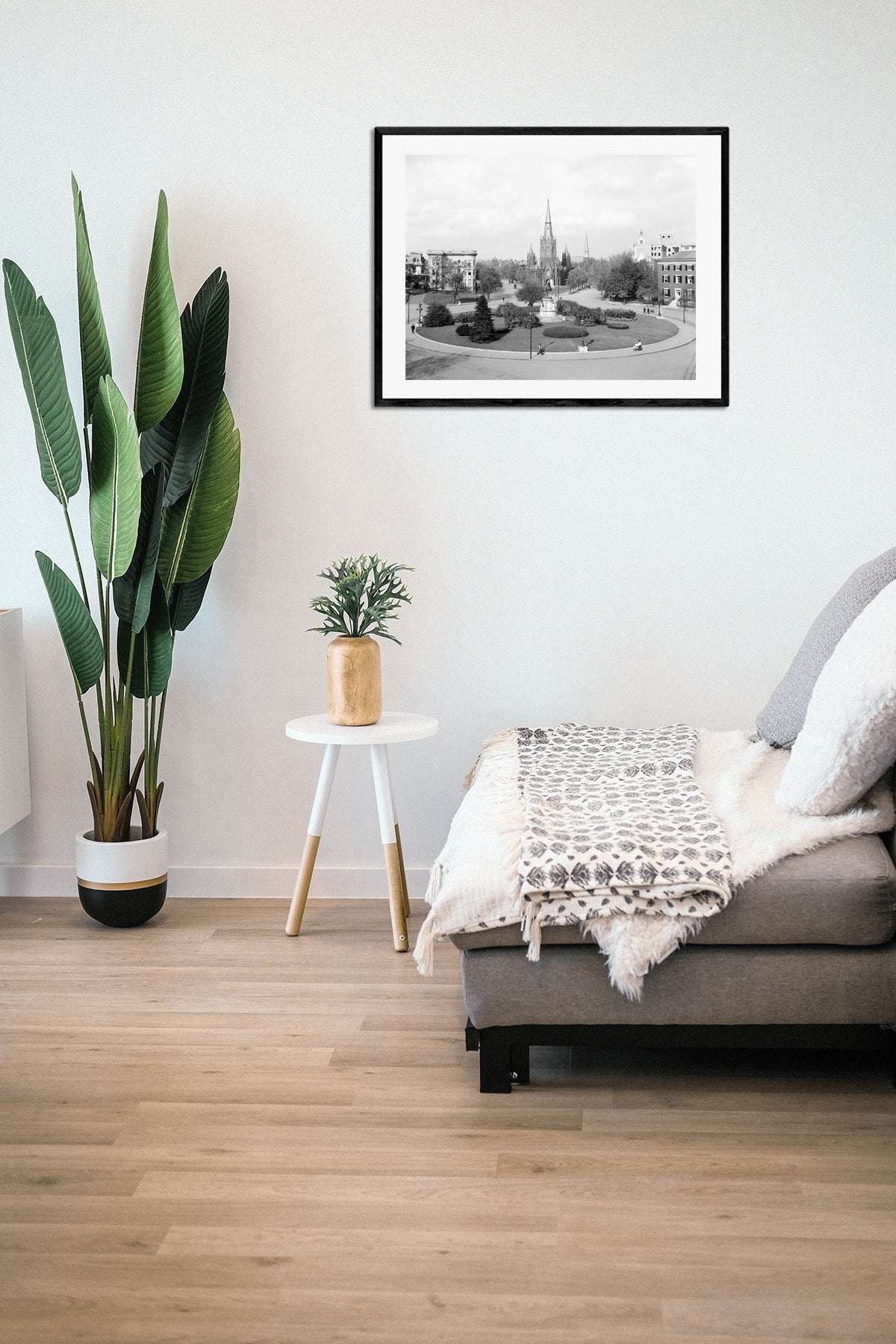 A living room with a framed paper print of a vintage image of Thomas Circle