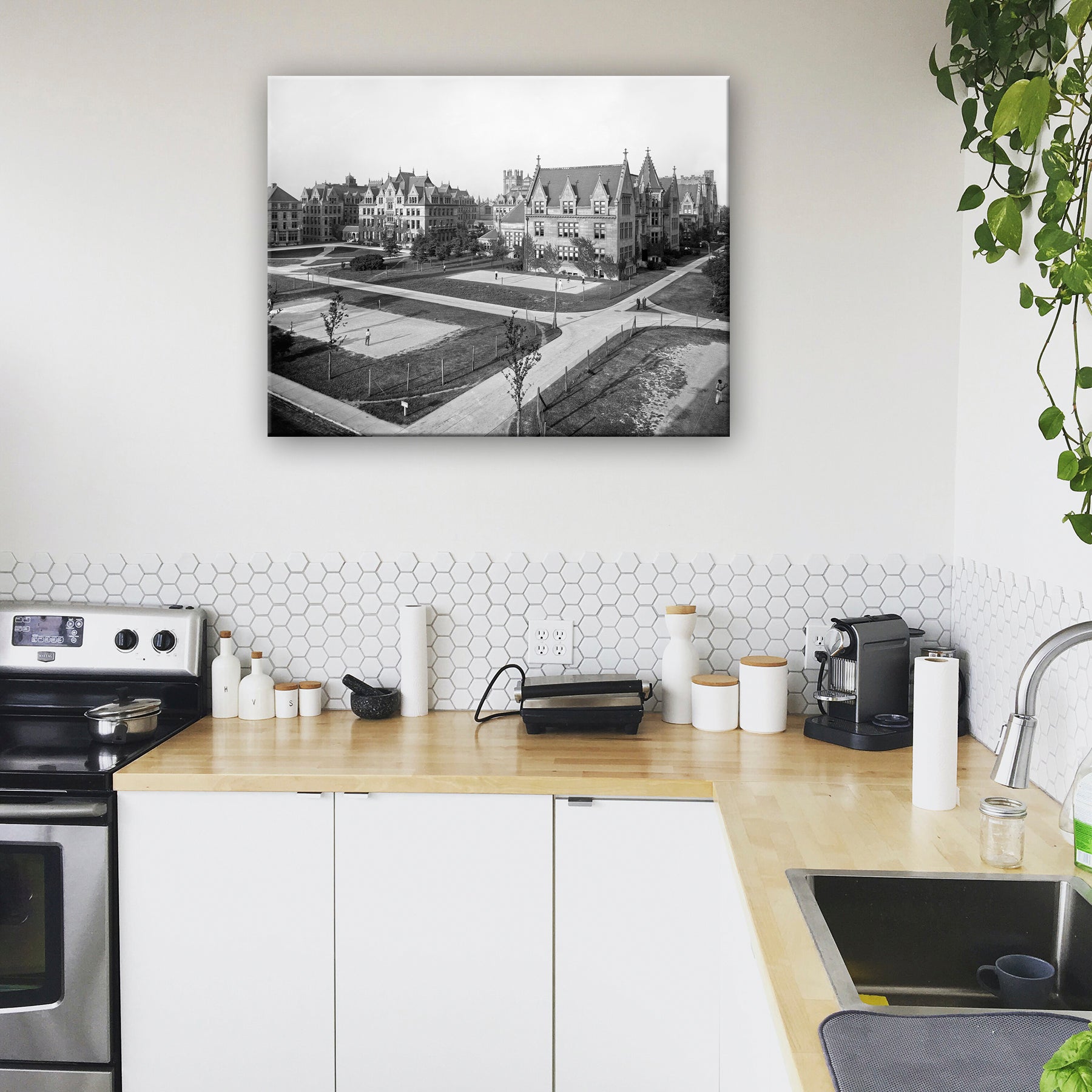 A canvas print of a vintage photograph of the University of Chicago hanging on a kitchen wall