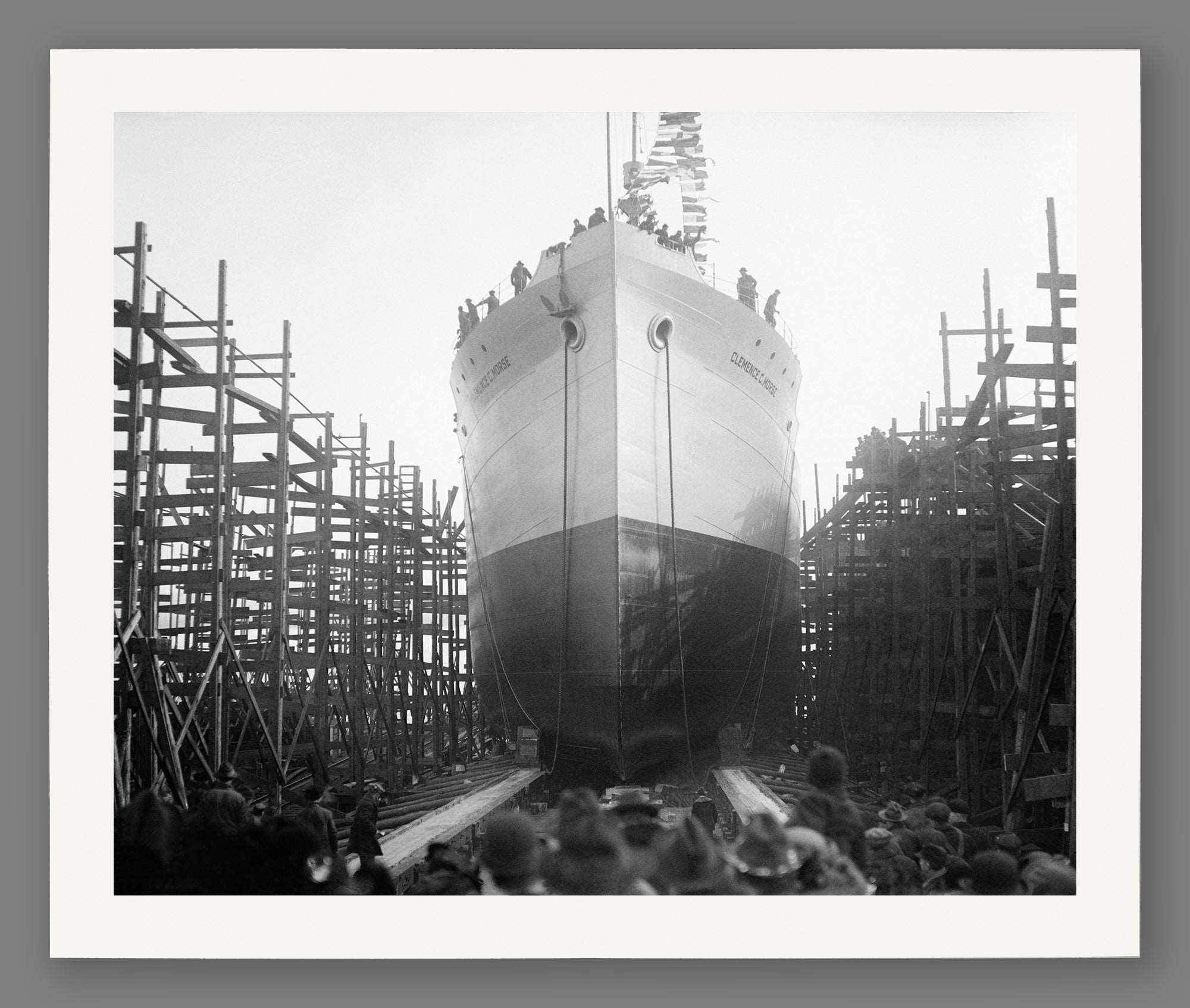 A paper print of a black and white photograph of a ship launch in Virginia