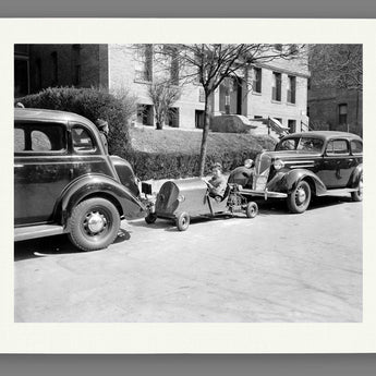 A fine art paper print of our vintage photograph of a Washington boy parking his miniature car