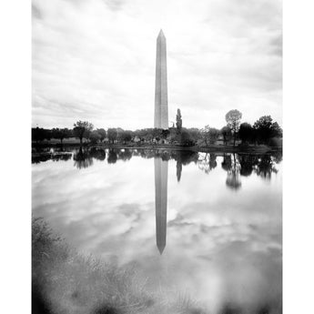 A vintage photograph of the Washington Monument and its reflection in water