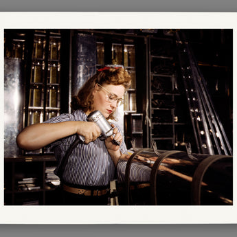A photograph of a woman using machinery as a print reproduction on paper