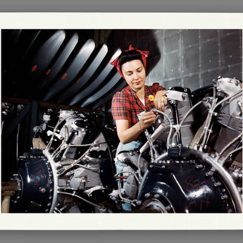 A sample of a paper print reproduction featuring vintage photography of a woman working on an airplane motor