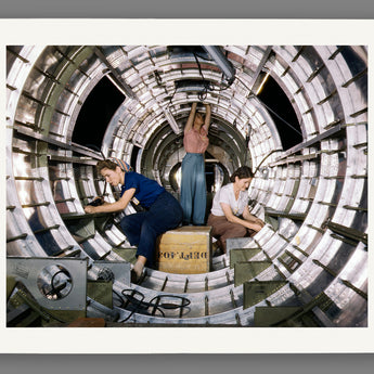 A template of a vintage photograph printed on paper, depicted a group of women working on a B-17 Bomber