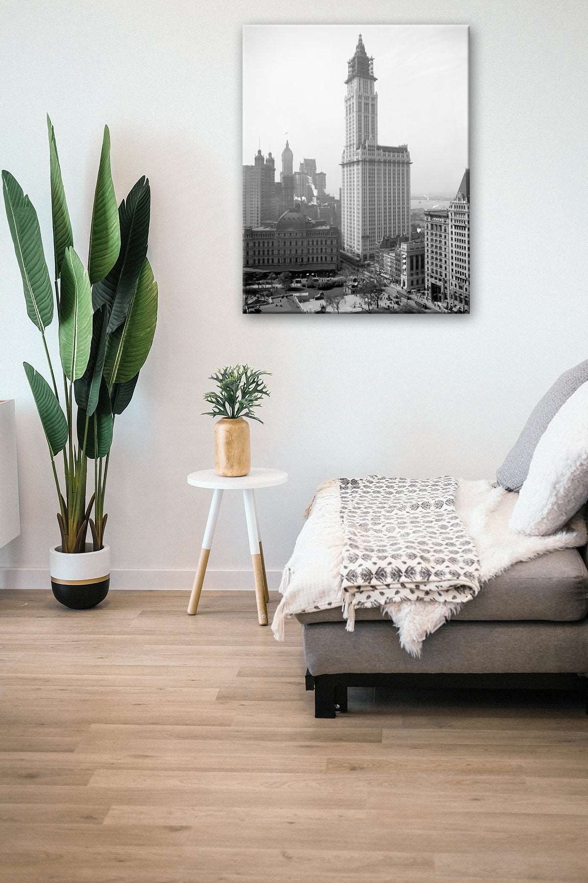 A canvas print reproduction hanging in a living room, featuring our vintage photograph of the Woolworth Building in New York City
