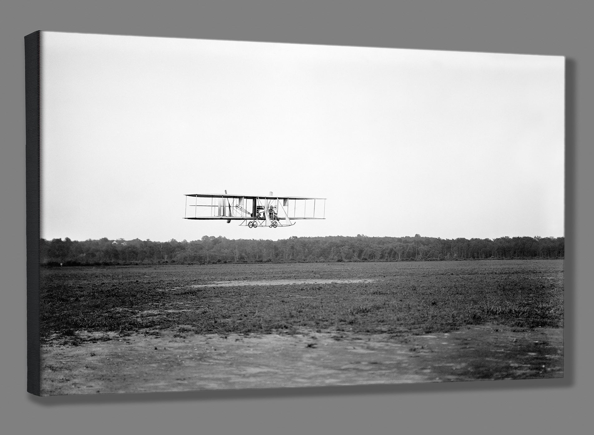 A stretched canvas print of a photograph of a Wright Biplane flying low