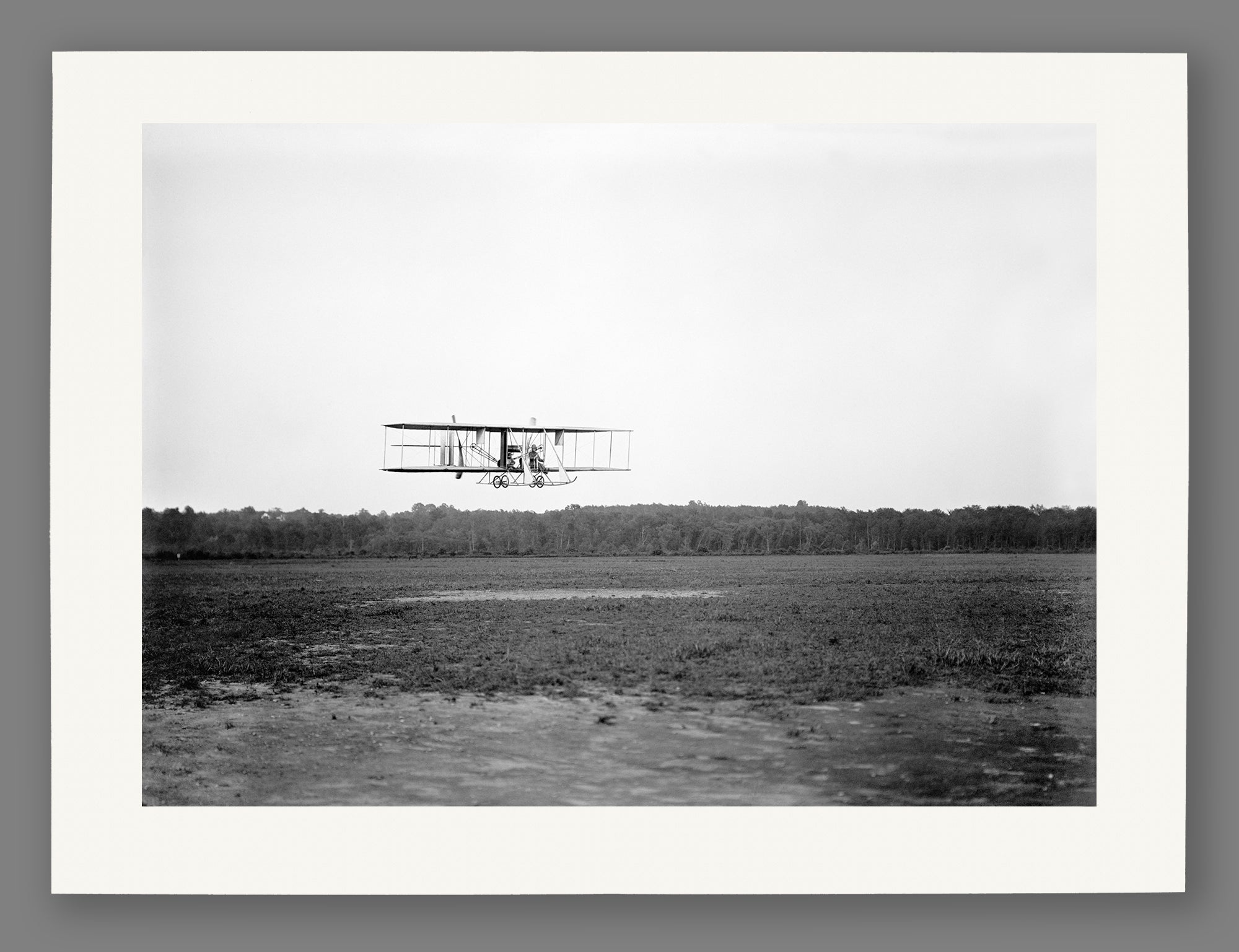 A paper print reproduction of a photograph of a Biplane at College Park Aviation Field