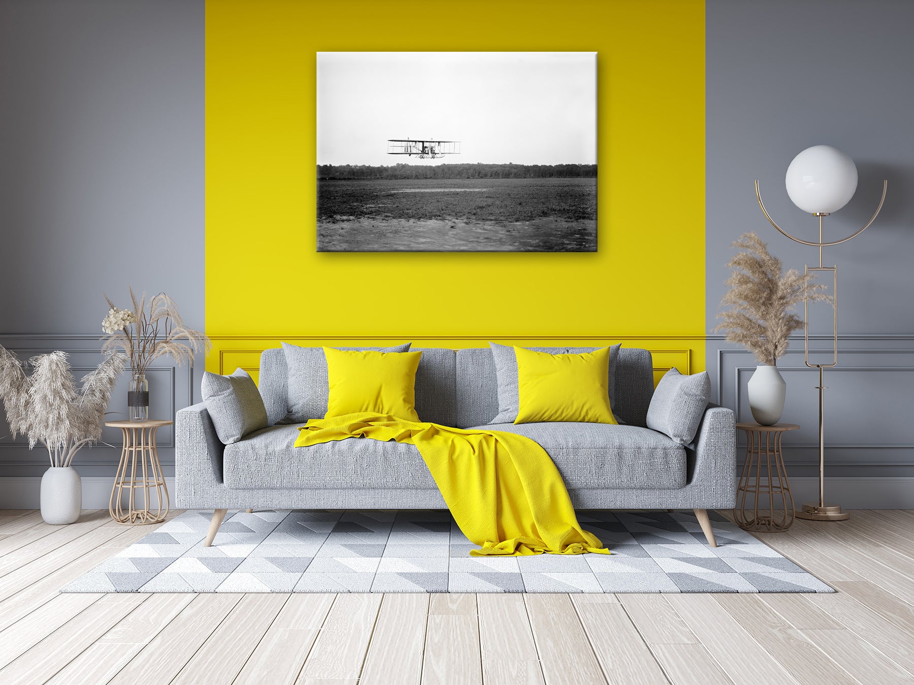 A living room with a yellow wall, with a stretched canvas print hanging on the wall